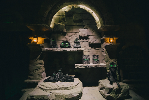 Campaign accessories arranged beneath a stone exhibition arch