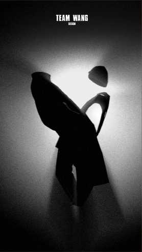 A twisting black garment silhouette beneath a suspended cap